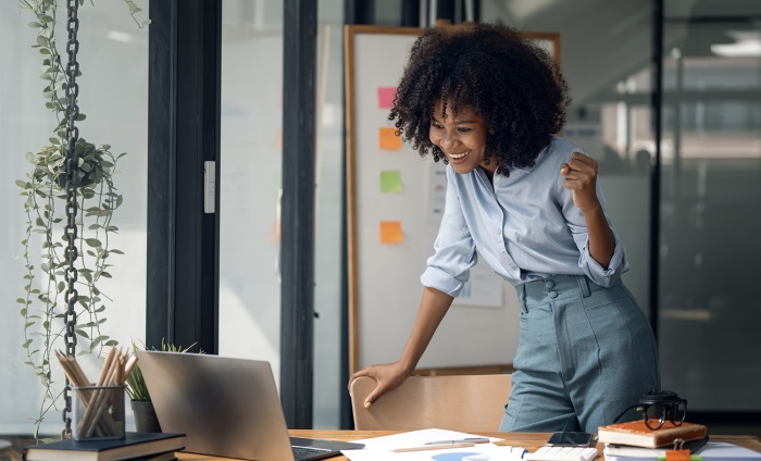 A business woman is excited about her work in her office