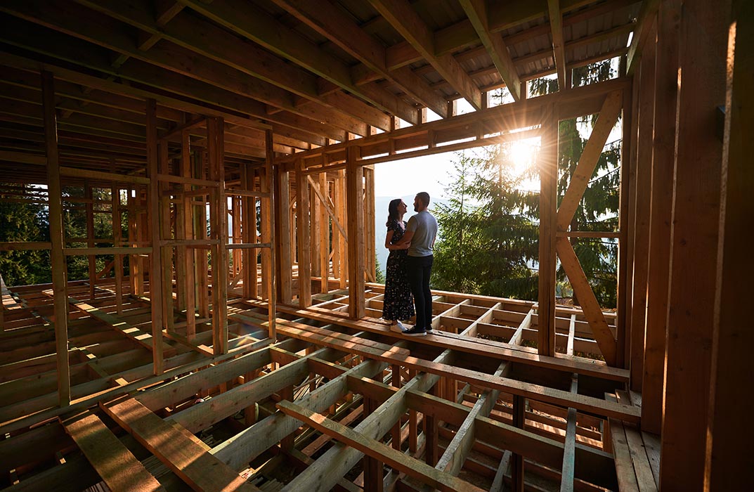 Couple appreciating their new home under construction