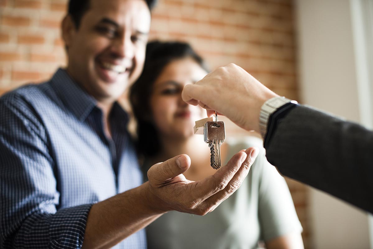 Couple receiving keys to their new home